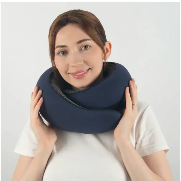 Woman sleeping comfortably on a plane with travel pillow